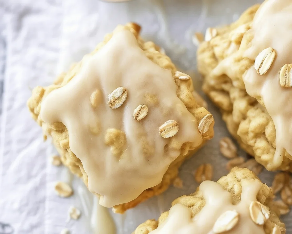 Freshly baked Maple-Oatmeal Scones topped with a sweet maple syrup glaze.