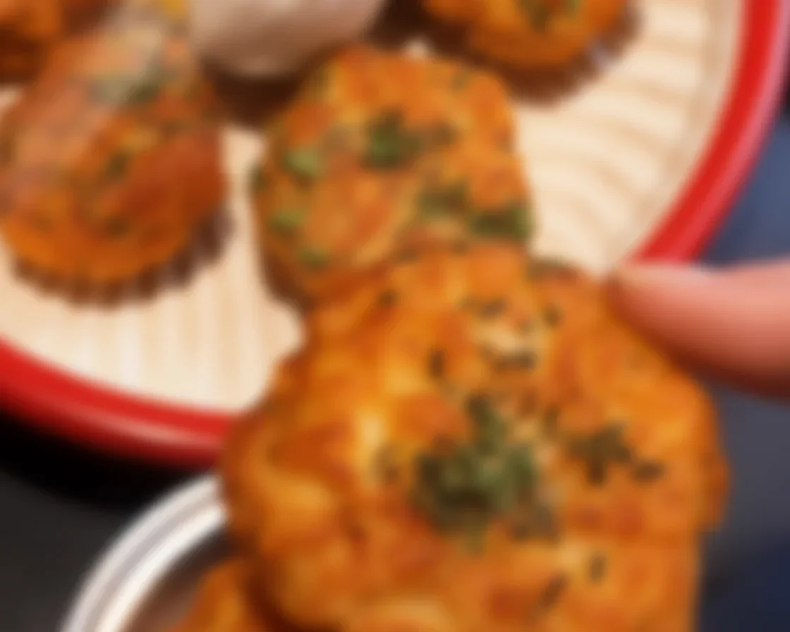 Plate of Garlic Parmesan Spicy Mozzarella Sticks served with marinara sauce.