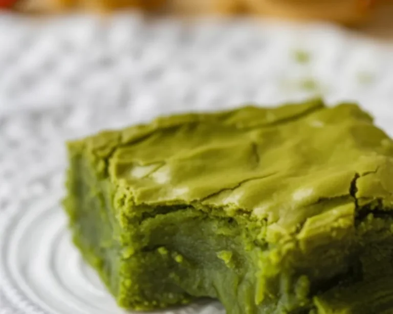 Fudgy Matcha Brownies topped with green tea glaze and chocolate chunks