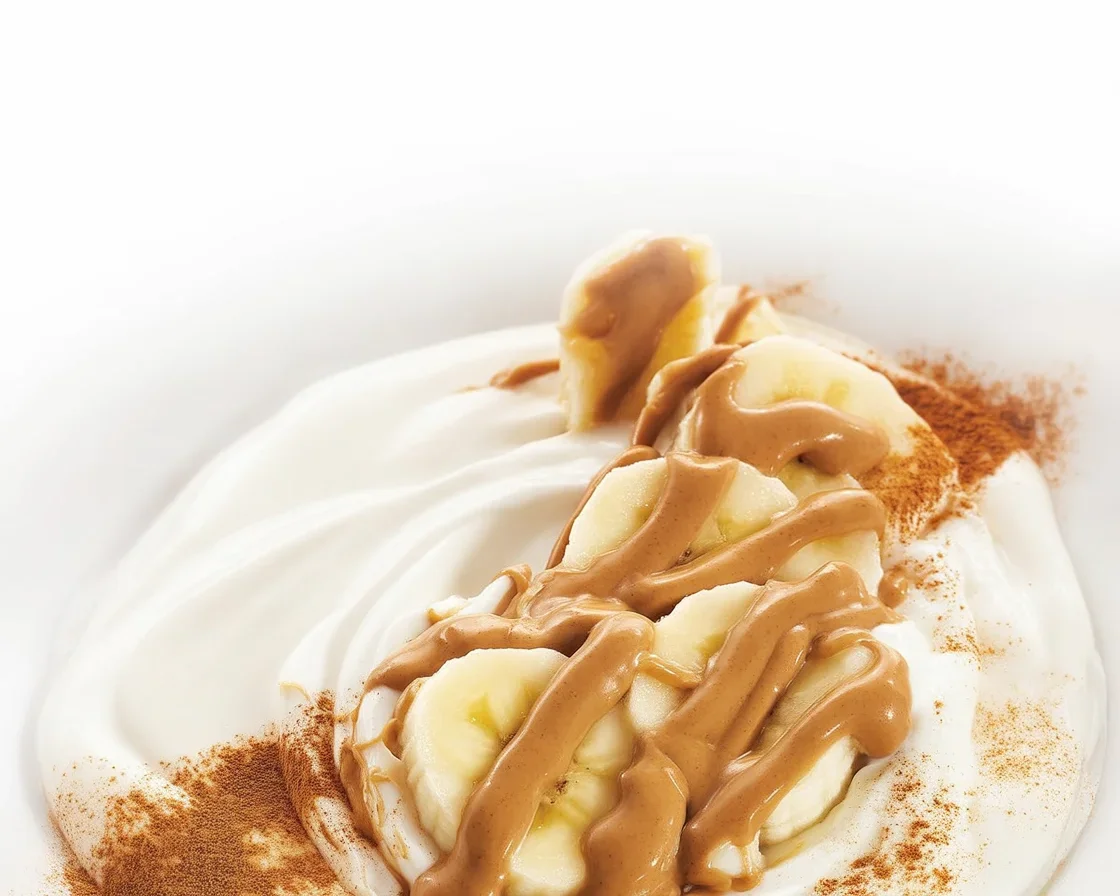 Banana Peanut Butter Yogurt Bowl topped with banana slices and creamy peanut butter.
