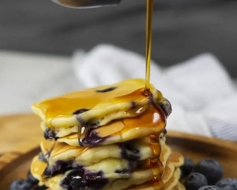 Delicious sheet pan pancakes made with Kodiak Cakes mix, topped with fresh blueberries.