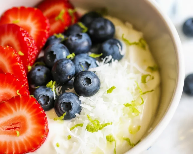 Tropical Yogurt Bowl with Mango Coconut topped with fresh fruits.