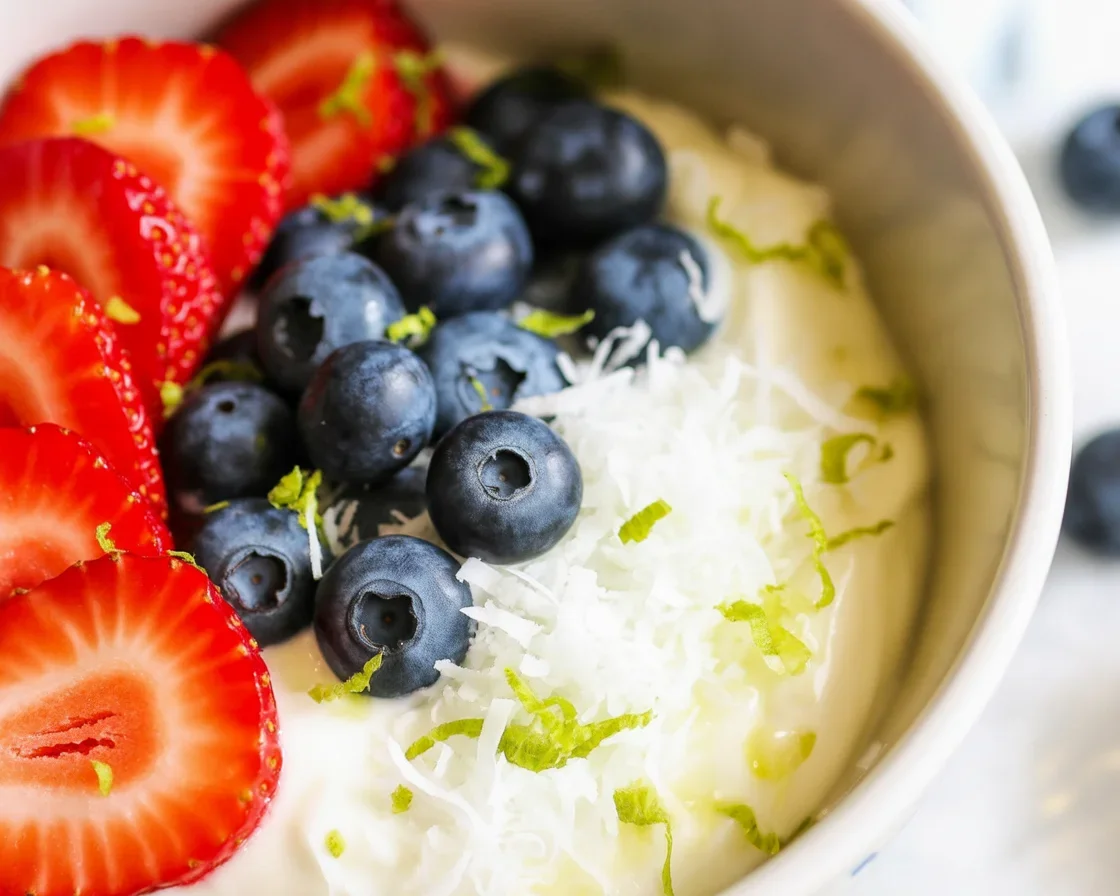 Tropical Yogurt Bowl with Mango Coconut topped with fresh fruits.