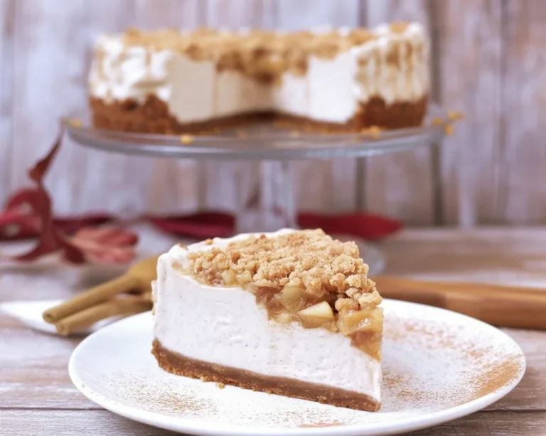 Delicious Vegan Apple Crumble Cheesecake with a creamy filling and spiced apples.